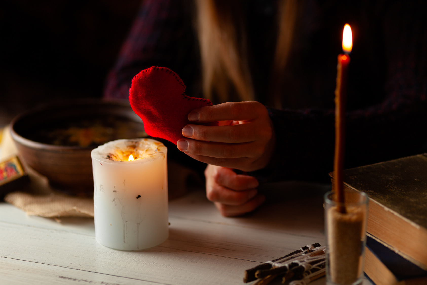 Red heart in hands of witch, love spell and broken heart, unrequited love. Psychic vision, fortune teller
